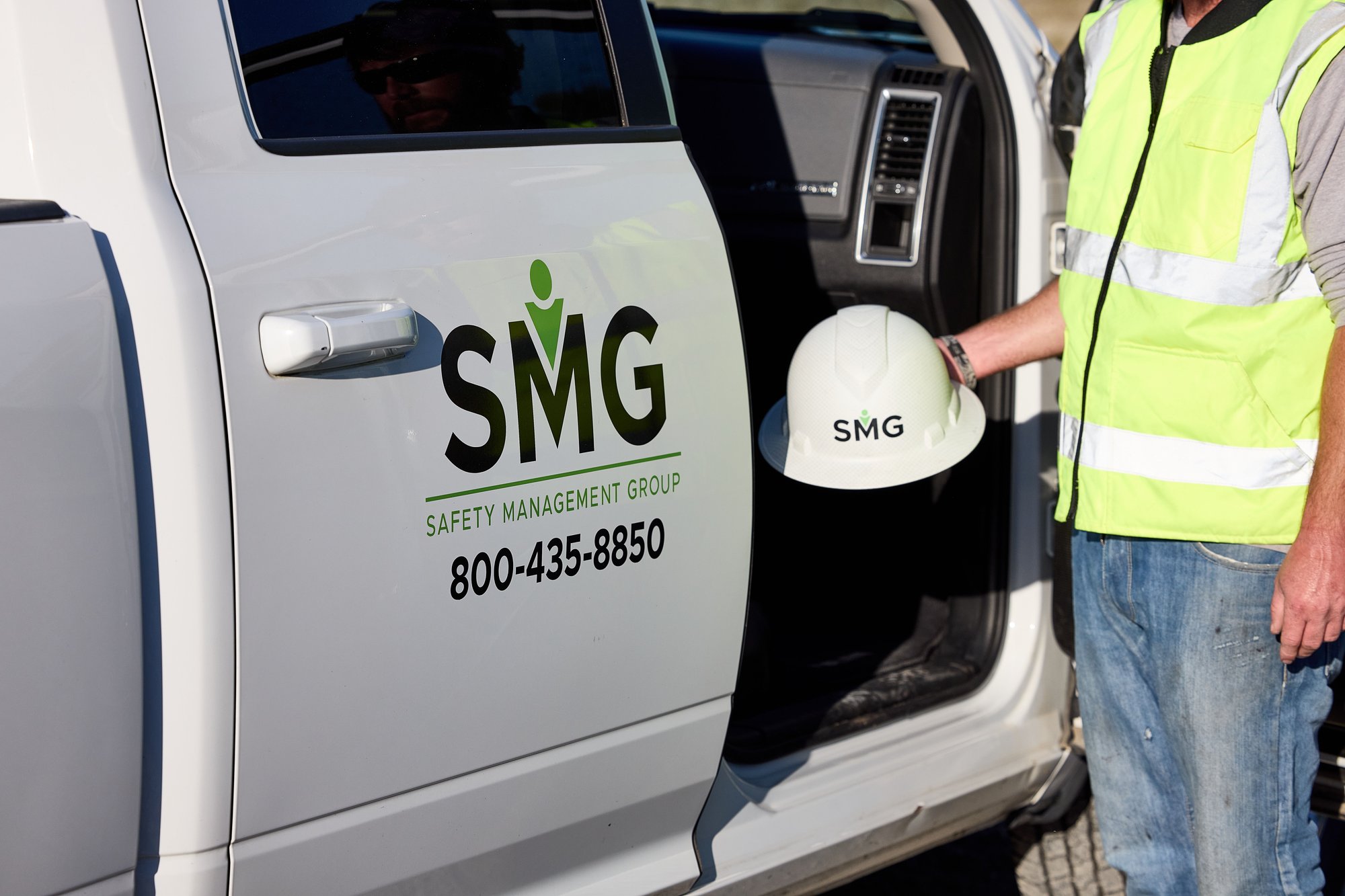 SMG Advisor holding hard hat